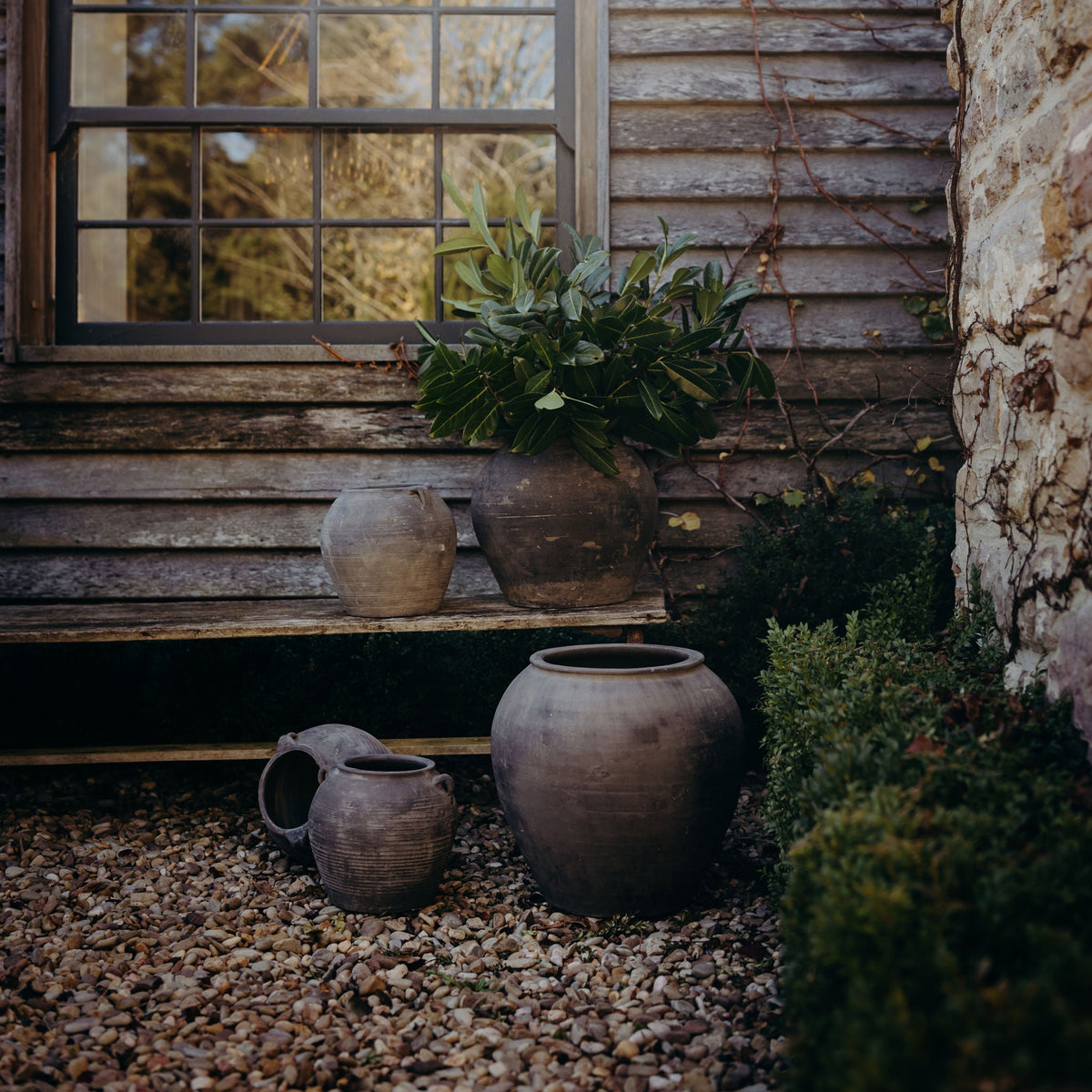 Vintage pots and pieces styled on a bench